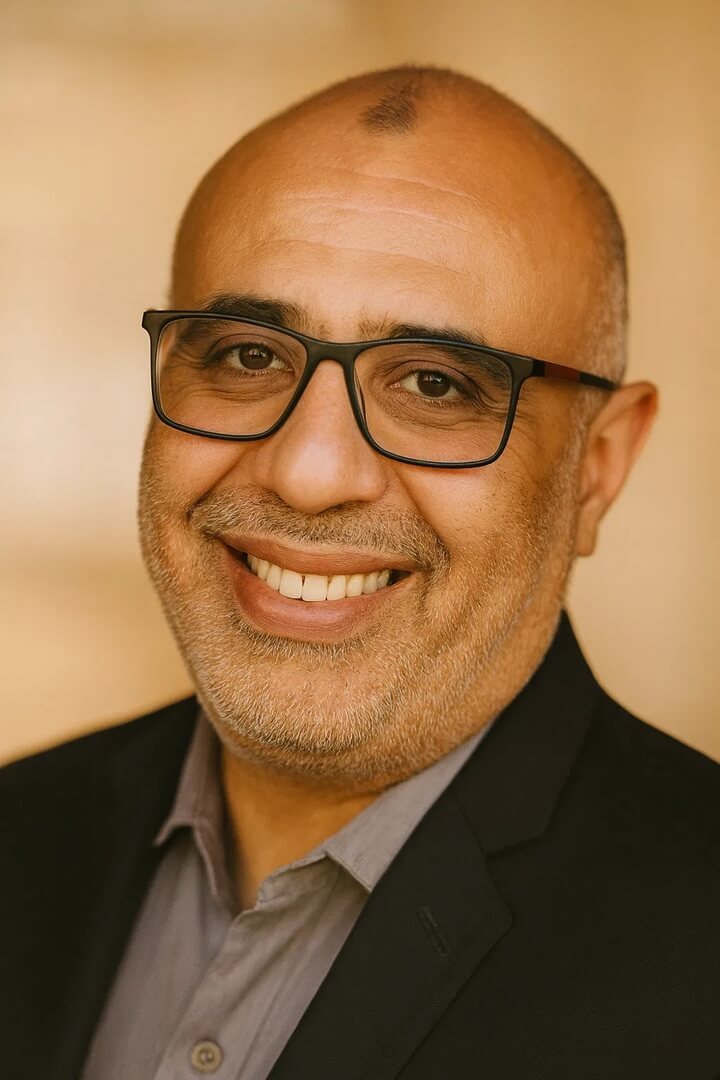 business owner Dr. Mostafa Kassem smiling in glasses and suit jacket