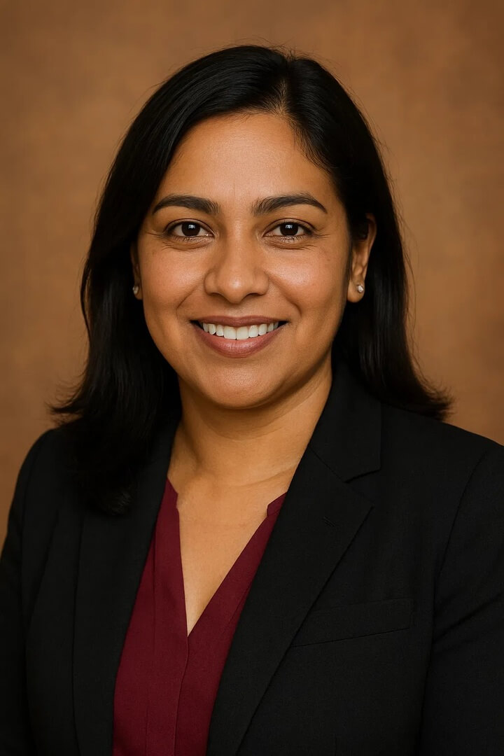 business owner Maria Serrano in business attire, smiling.