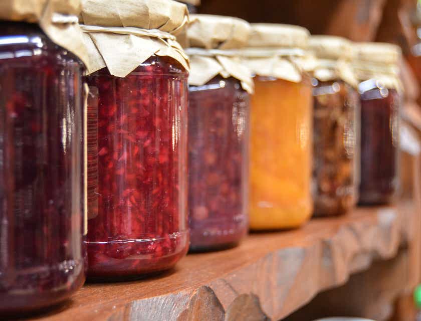A collection of glass jars containing preserved foods.