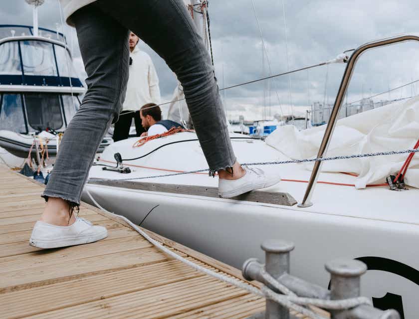 A close-up of a step taken by a person boarding a yacht belonging to a nautical business.