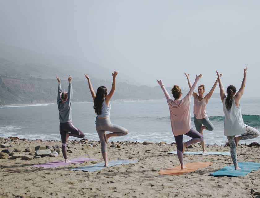 'Een groep vrouwen die aan yoga op het strand doen voor een gezonde levensstijl.