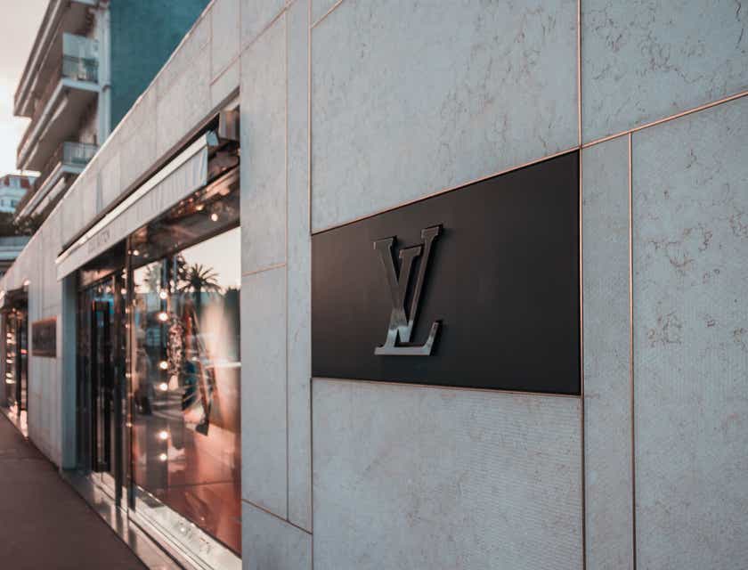 Cuplikan logo avant-garde merek Louis Vuitton di sisi sebuah bangunan.