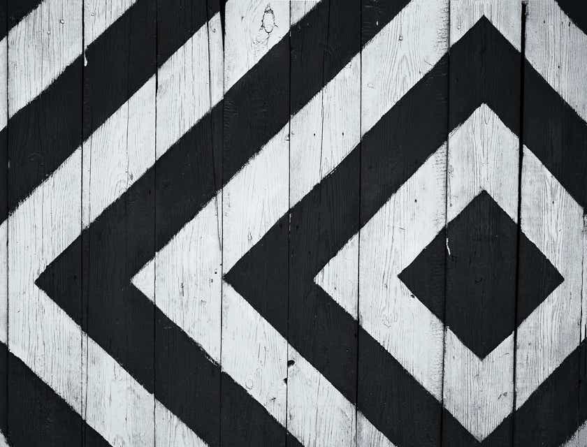 Une planche de bois avec des rayures triangulaires en noir et blanc.