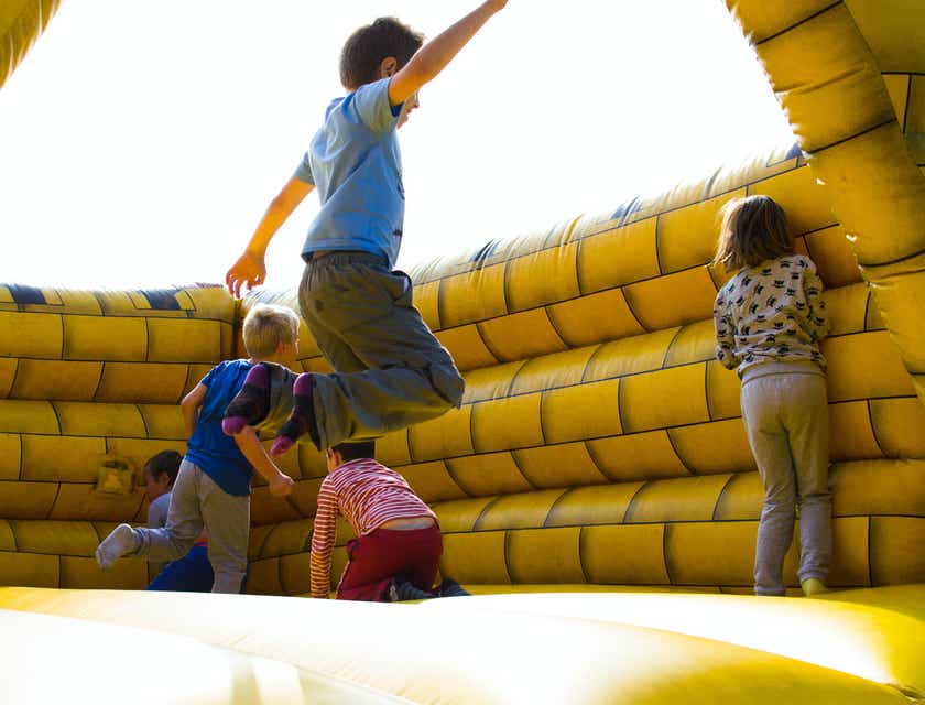 A group of children playing in a bouncy castle.