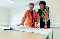 A contractor explaining renovation plans to a client.