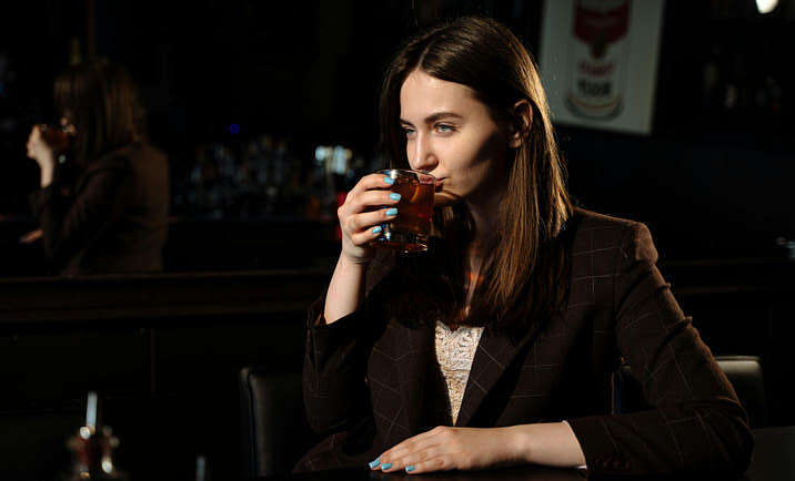 A person drinking an alcoholic beverage.