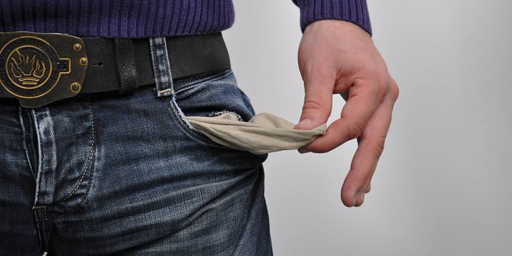 A person with empty jean pockets and no money.