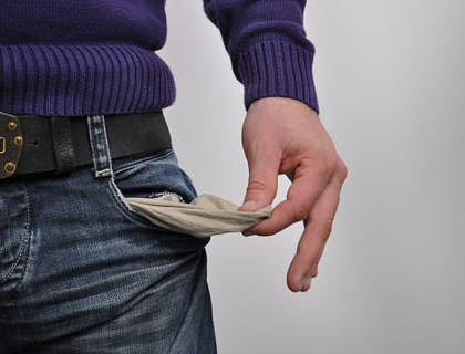A person with empty jean pockets and no money.