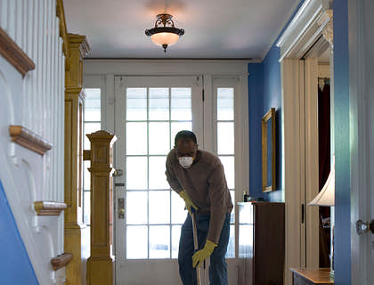Man cleaning the foyer of a house