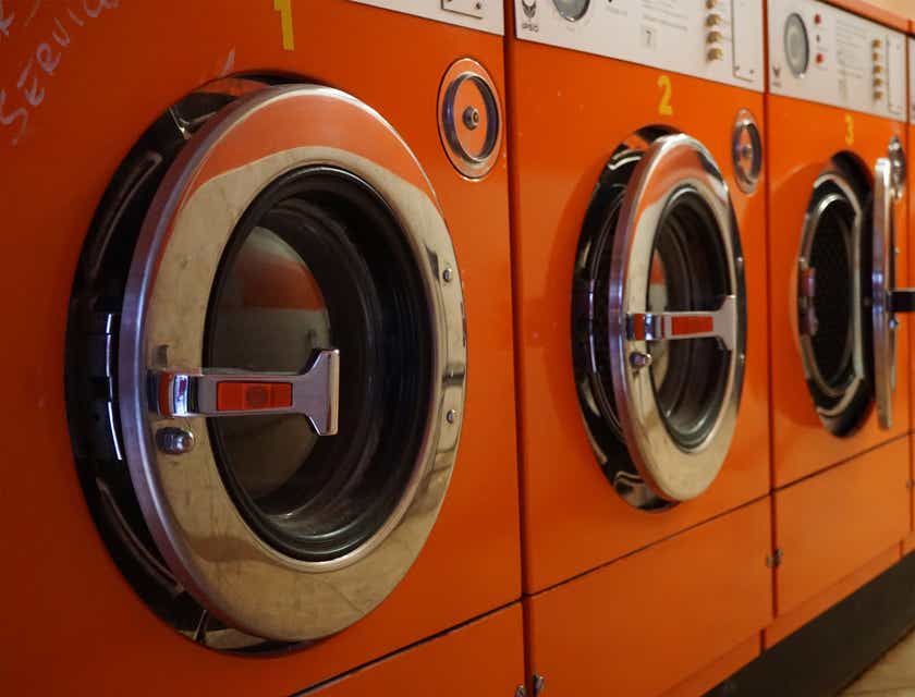 red front loader washing machines in a laundromat