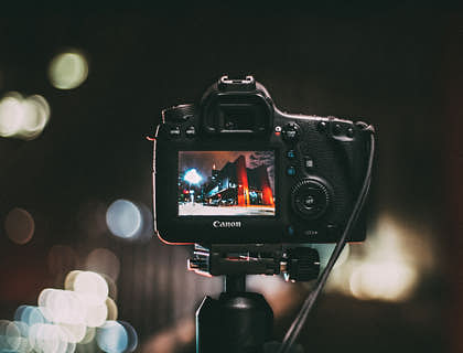 DSLR camera on a tripod capturing a building