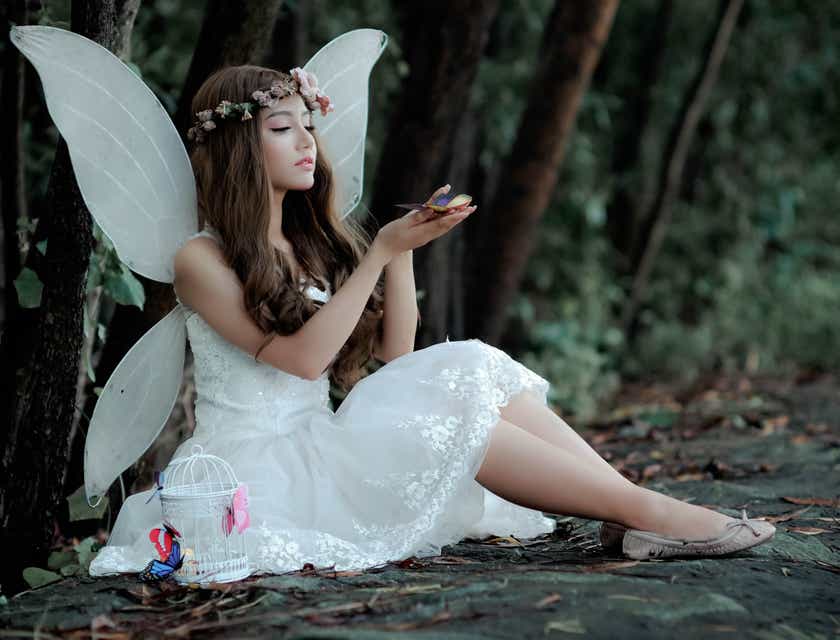 A woman in fairy cosplay appears ethereal in white.