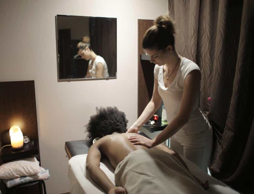 A woman receiving a massage in a massage parlor.