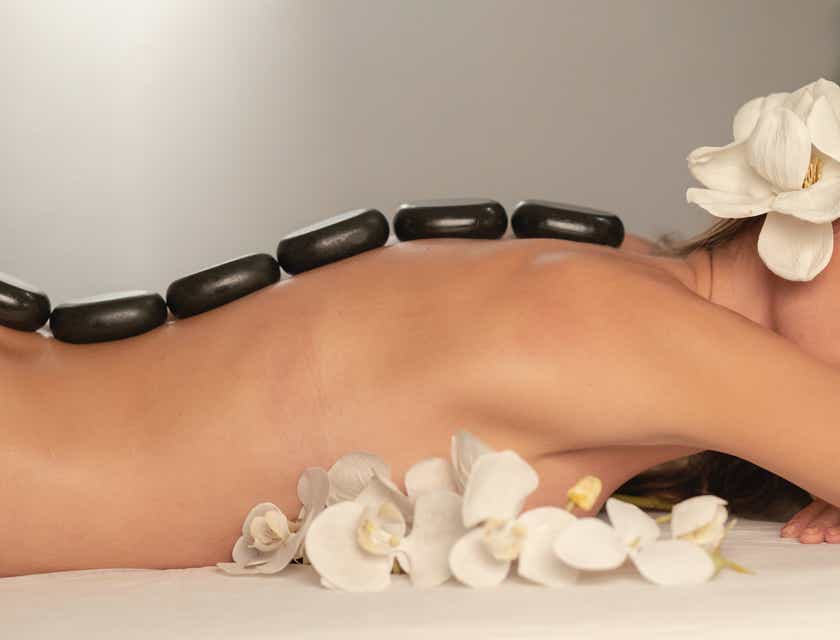 A woman with hot stones on her back at a medical spa.
