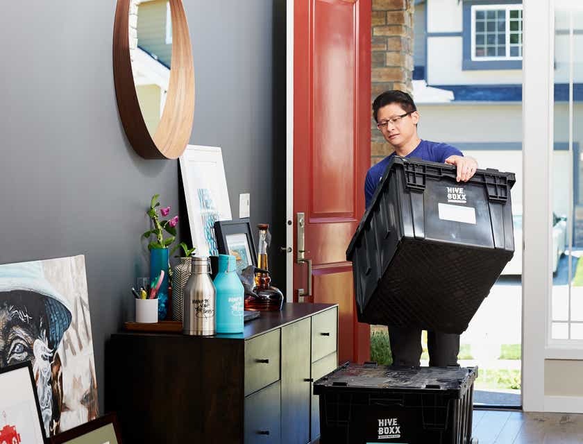 Un empleado traslada las pertenencias de un cliente a un nuevo hogar en un logo para mudanzas.