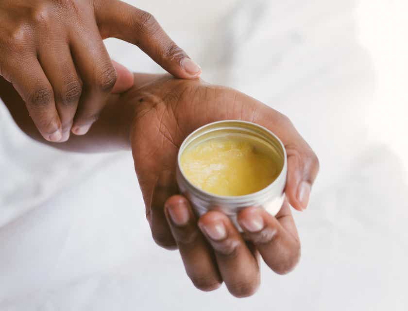 A woman applying product to her skin as part of her personal care ritual.