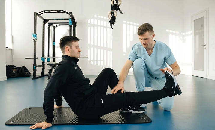 A physical therapist working with a patient.