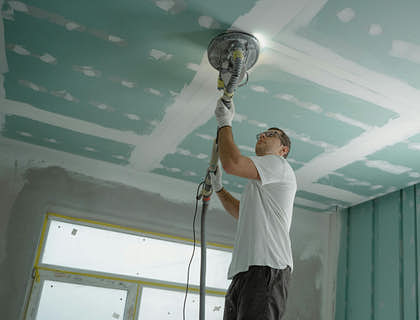 A person performing property maintenance tasks in a residential building.