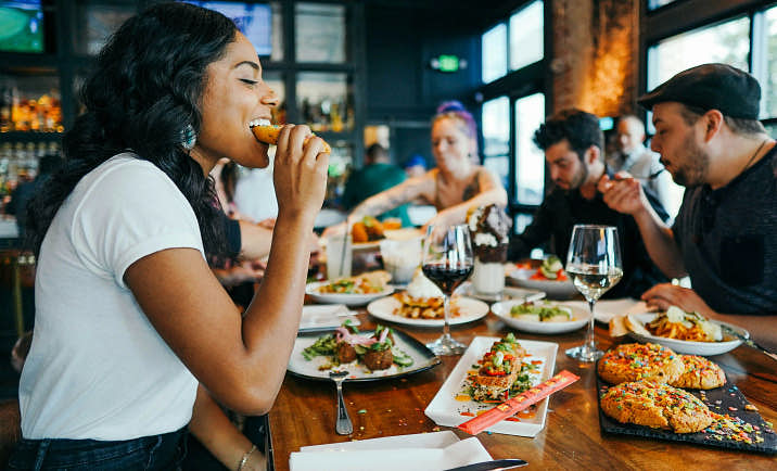 A group of people enjoying a meal at a restaurant.