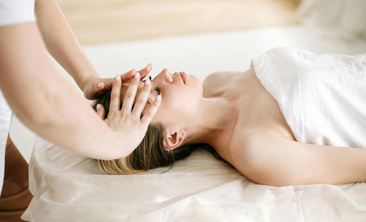 A person receiving a facial massage during a spa treatment.