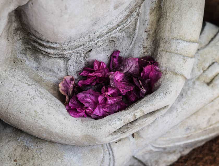 A ceremonial statue with purple flowers used in a spiritual coaching practice.