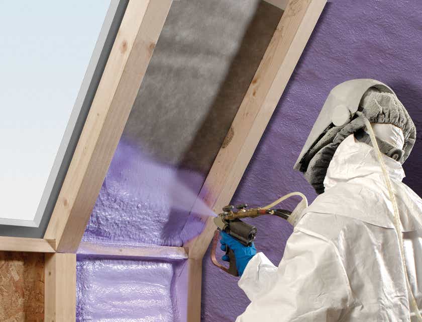 A person applying spray foam in a house.