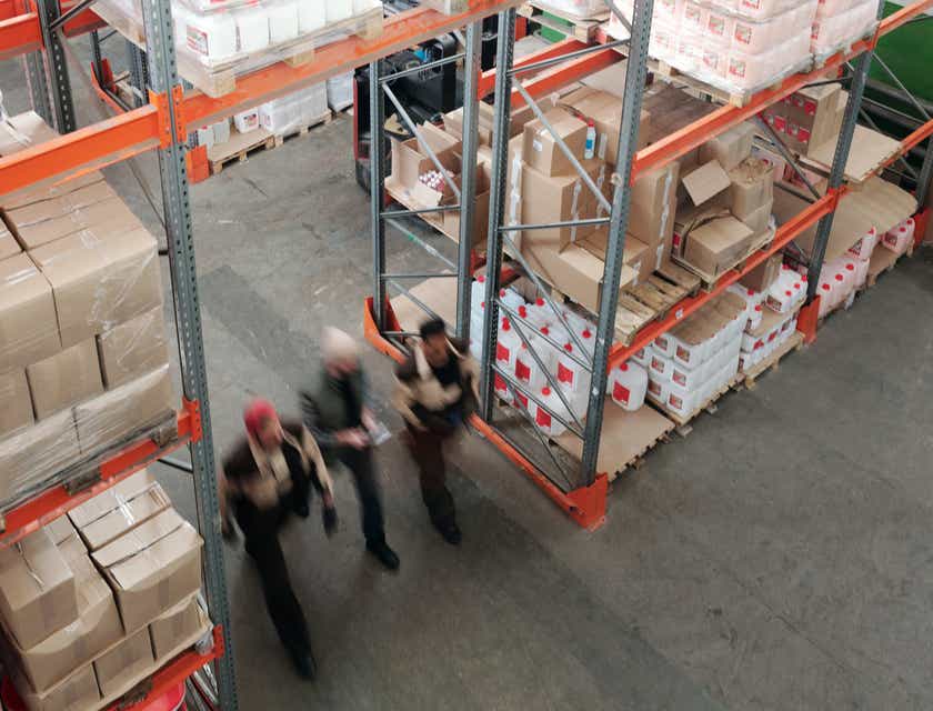 People walking through a supply warehouse.
