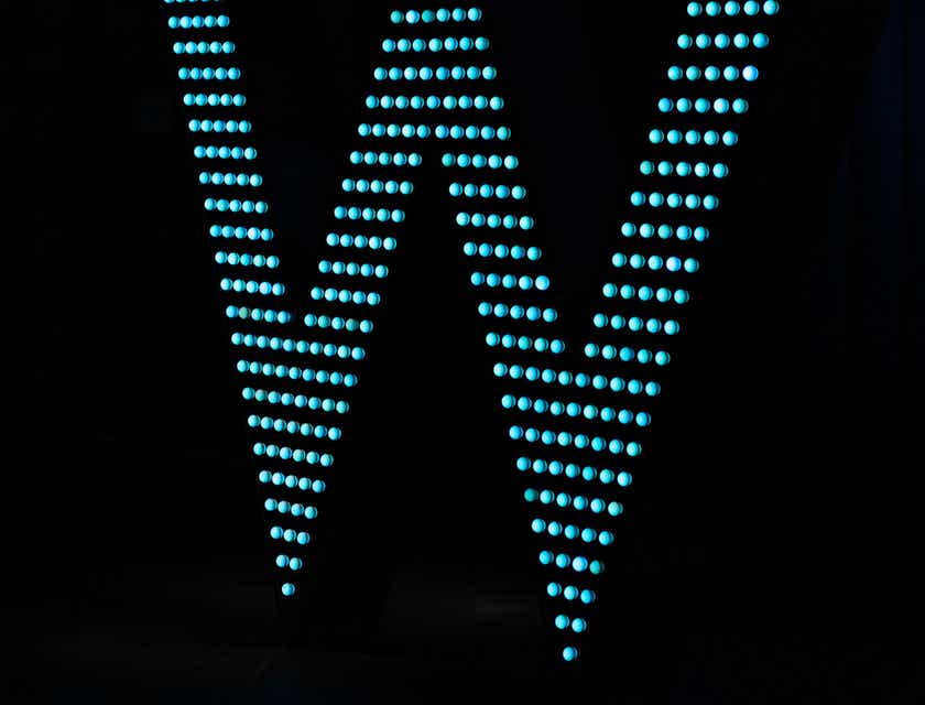 The letter "W" lit up in LED lights.