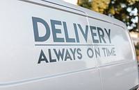 A delivery van displaying the business's slogan.