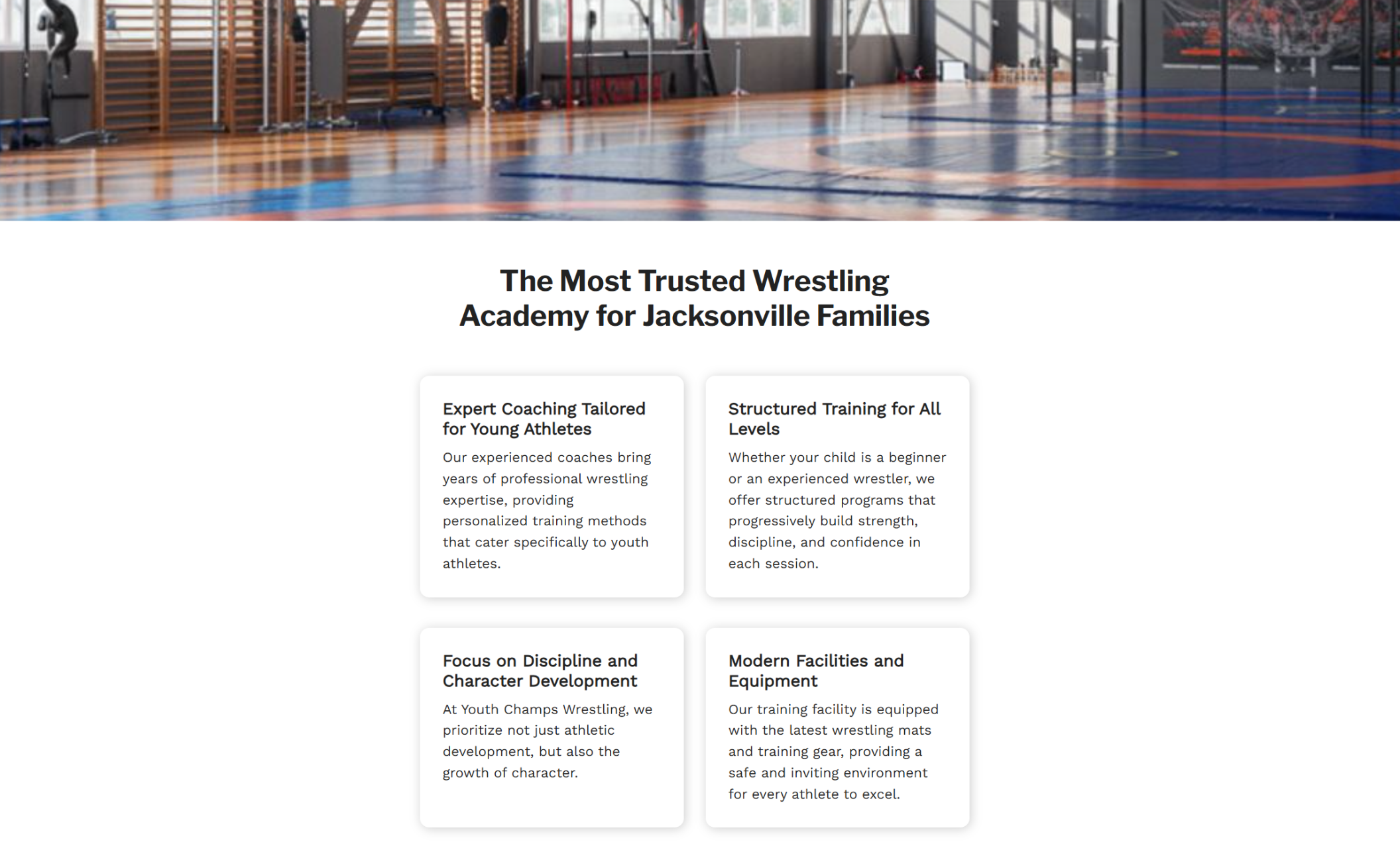 Youth Champs Wrestling features section showing a brightly lit training gym with wrestling mats behind four service cards under the headline ‘The Most Trusted Wrestling Academy for Jacksonville Families.’